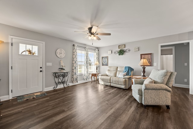 living room with ceiling fan and dark wood-type flooring