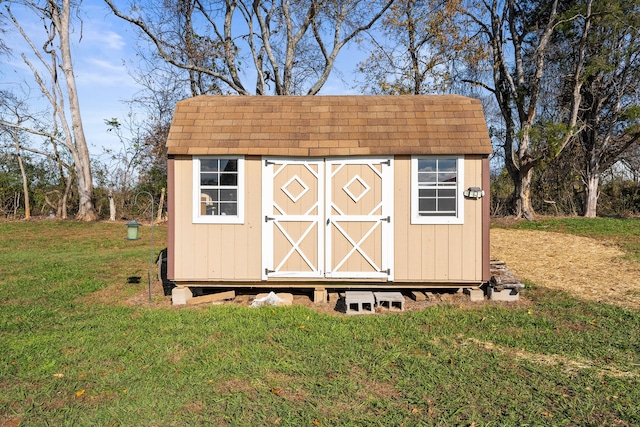 view of outdoor structure featuring a lawn