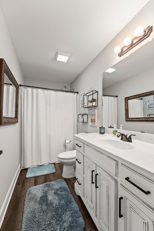 bathroom featuring hardwood / wood-style floors, vanity, and toilet