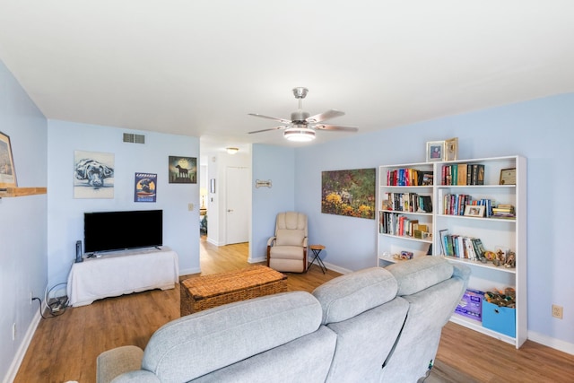 living room with light hardwood / wood-style flooring and ceiling fan