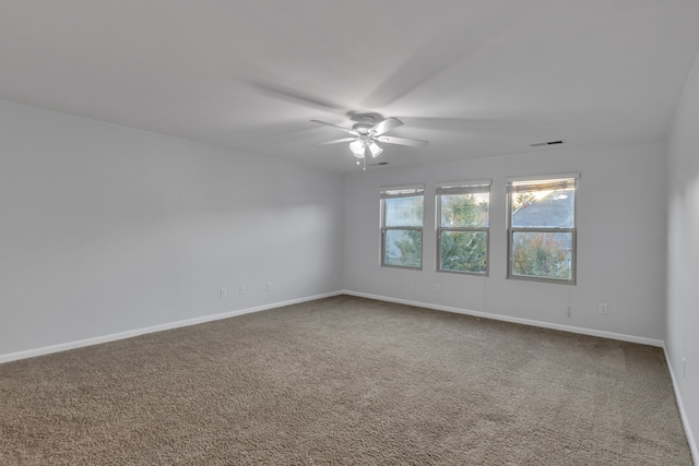 empty room with ceiling fan and carpet floors