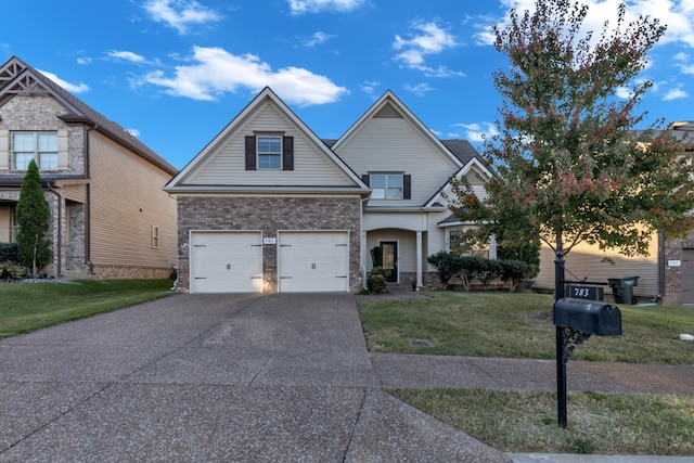 view of front of home with a front lawn and a garage