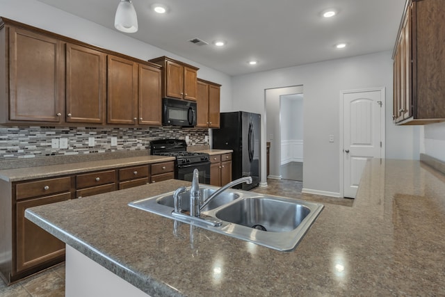 kitchen with backsplash, sink, and black appliances