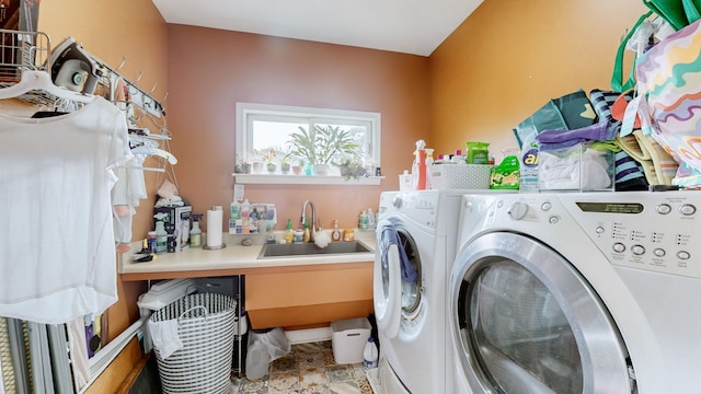 laundry room with washer and clothes dryer and sink