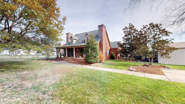 new england style home with covered porch and a front yard