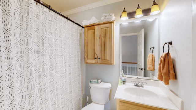 bathroom with walk in shower, crown molding, vanity, and toilet