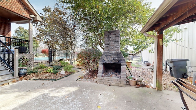 view of patio / terrace featuring exterior fireplace