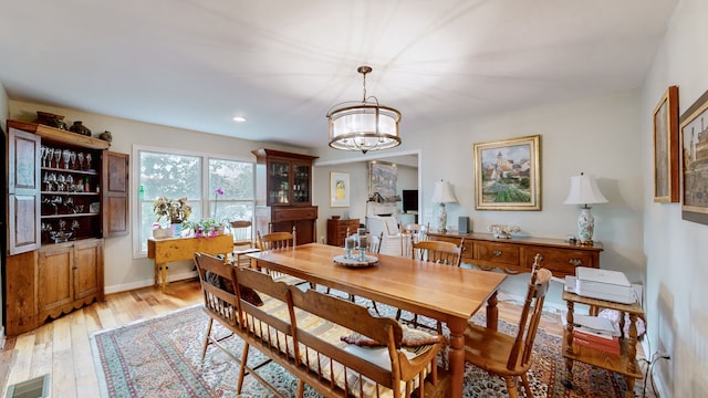 dining area featuring a chandelier and light hardwood / wood-style floors