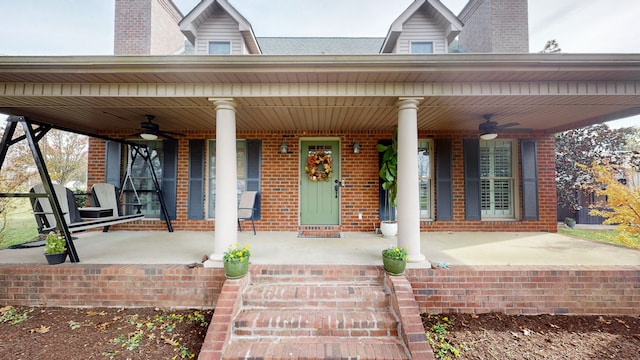 property entrance featuring ceiling fan and a porch