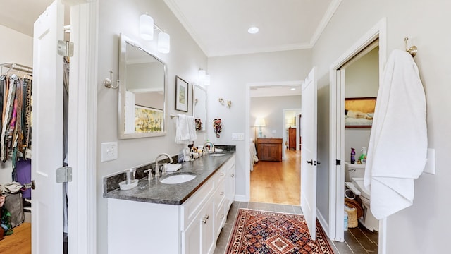 bathroom featuring hardwood / wood-style floors, vanity, and ornamental molding