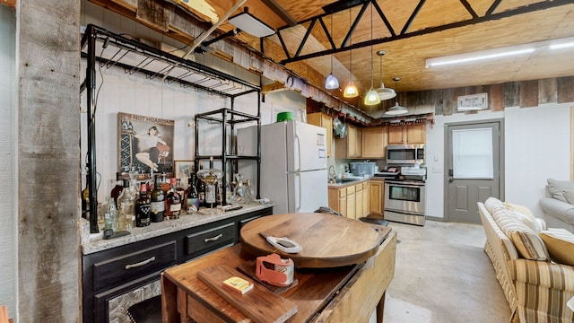 kitchen featuring decorative light fixtures, sink, and stainless steel appliances