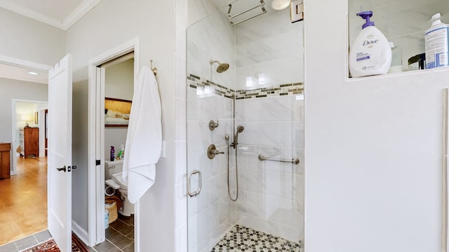 bathroom featuring wood-type flooring, walk in shower, and ornamental molding