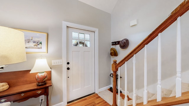 entrance foyer with light hardwood / wood-style floors and vaulted ceiling