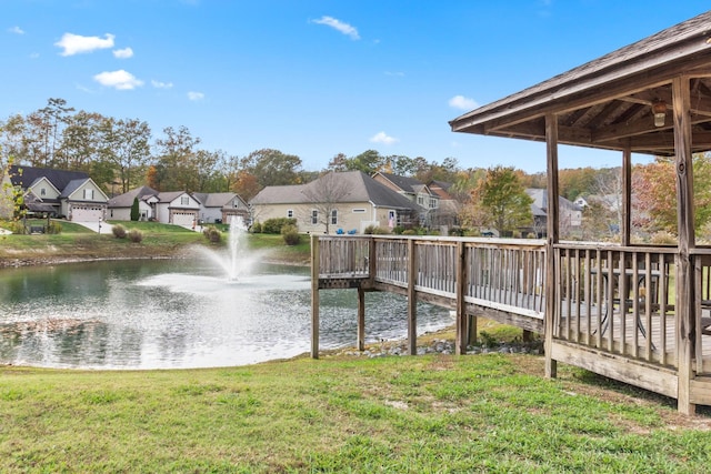 dock area featuring a yard and a water view