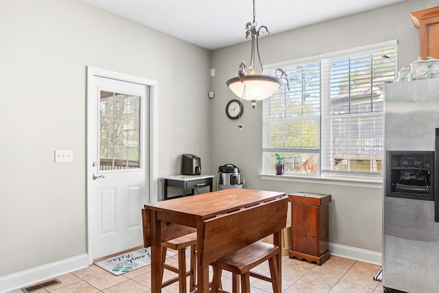 dining space featuring light tile patterned floors