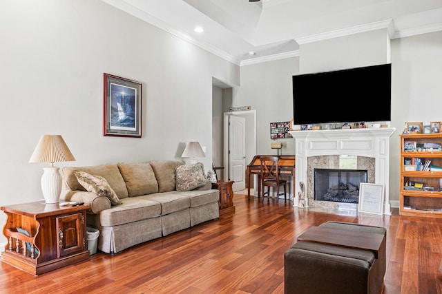 living room featuring hardwood / wood-style floors, crown molding, and a high ceiling