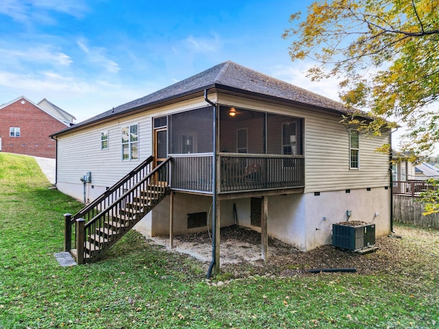 back of property with a sunroom, central air condition unit, and a yard