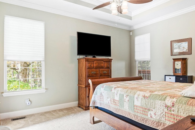 bedroom featuring multiple windows, ceiling fan, light carpet, and ornamental molding