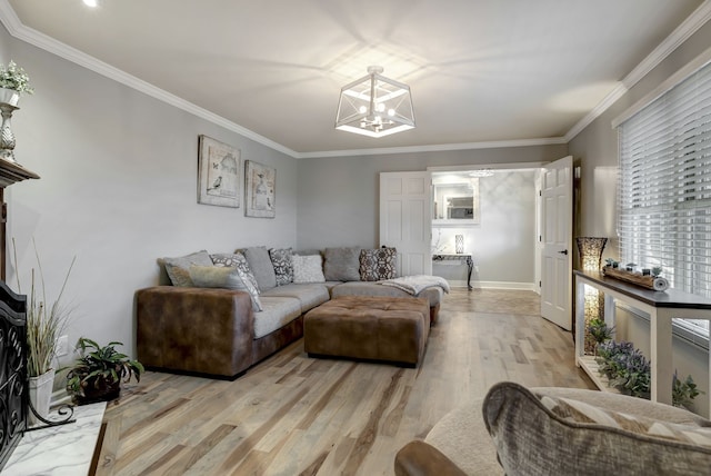 living room with a notable chandelier, crown molding, and light hardwood / wood-style flooring