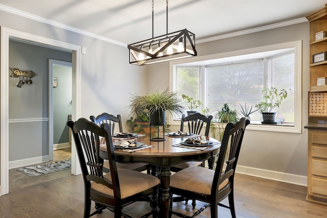 dining room with dark wood-type flooring and ornamental molding