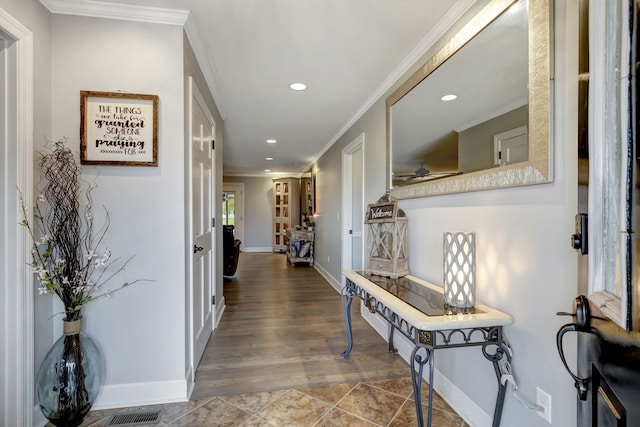 hallway with hardwood / wood-style flooring and ornamental molding