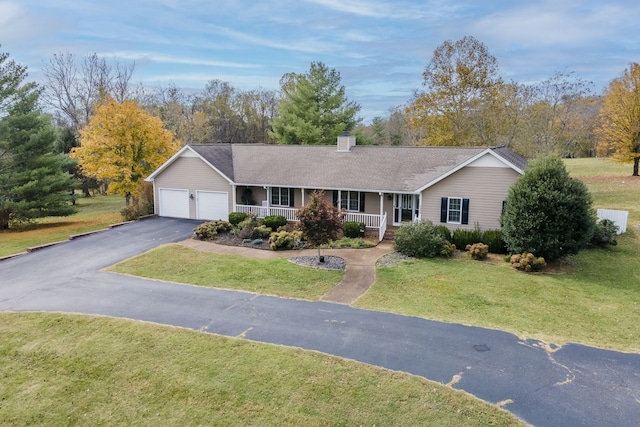 single story home featuring a front yard, a porch, and a garage