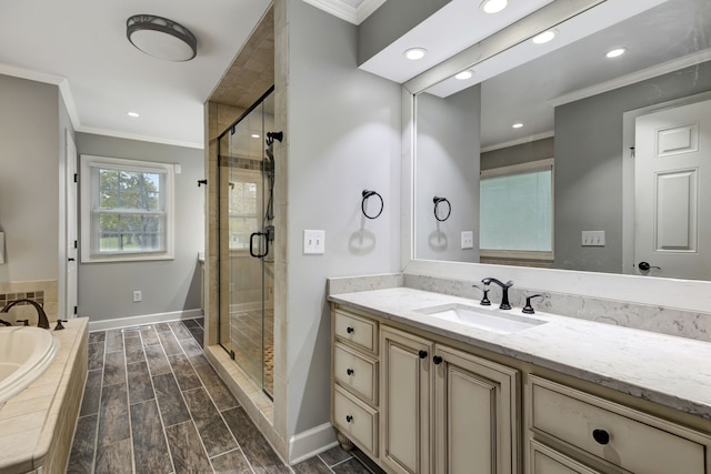 bathroom featuring crown molding, vanity, and shower with separate bathtub