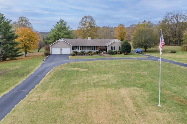 ranch-style home with a front lawn and a garage