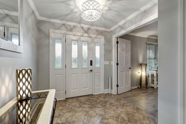 foyer entrance with crown molding, wood-type flooring, and an inviting chandelier