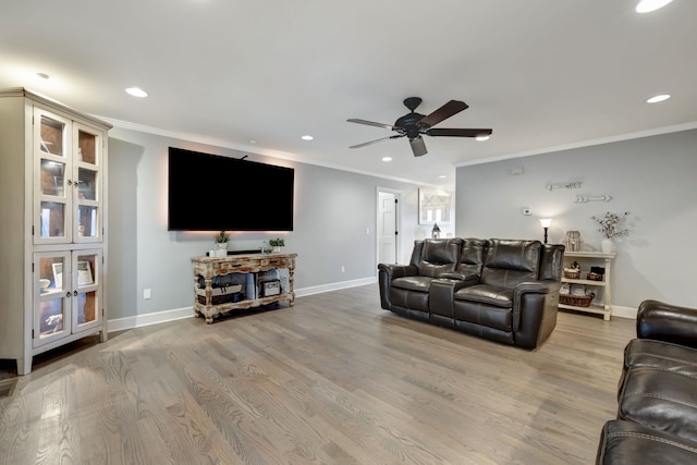 living room featuring ceiling fan, wood-type flooring, and ornamental molding