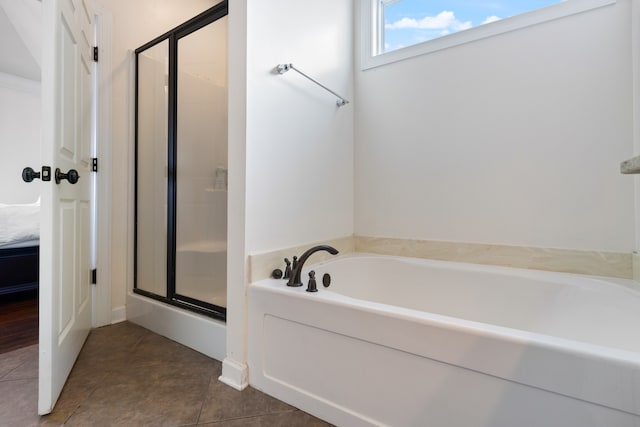 bathroom featuring plus walk in shower and tile patterned flooring