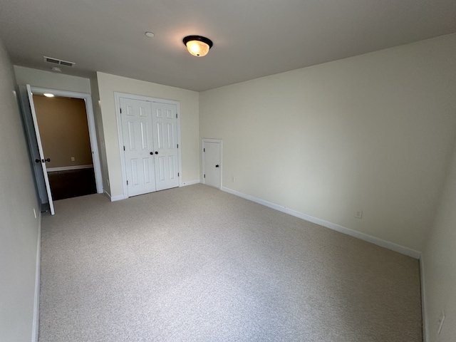 unfurnished bedroom with carpet and a closet