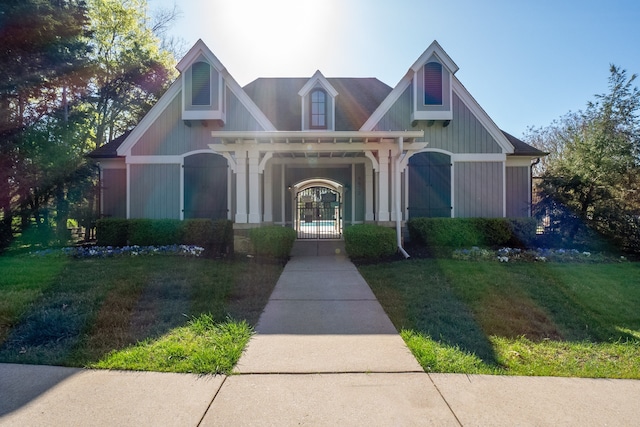 view of front of house with a porch and a front yard