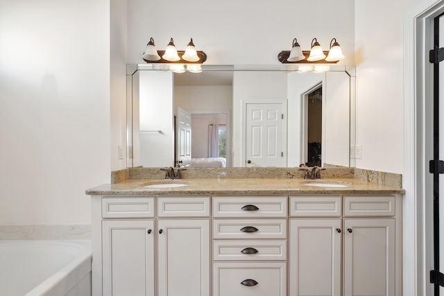 bathroom featuring vanity and a relaxing tiled tub