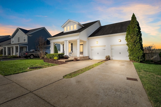 view of front of house featuring a garage and a lawn