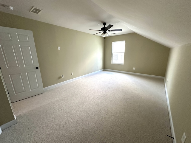 additional living space with light carpet, ceiling fan, and lofted ceiling