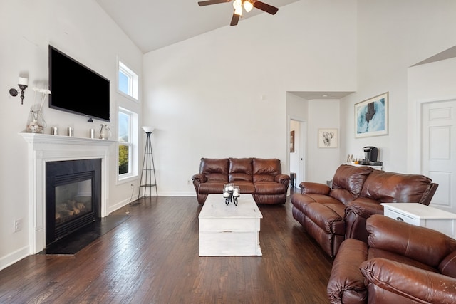 living room featuring ceiling fan, dark hardwood / wood-style flooring, and high vaulted ceiling