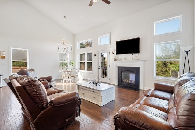 living room featuring a wealth of natural light, high vaulted ceiling, and dark hardwood / wood-style floors