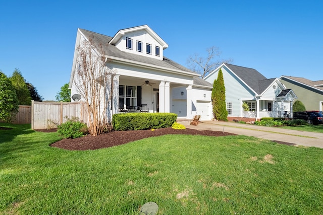 view of front of home featuring ceiling fan, a porch, and a front yard