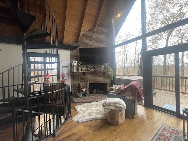 living room with wood ceiling, a fireplace, high vaulted ceiling, and wood-type flooring