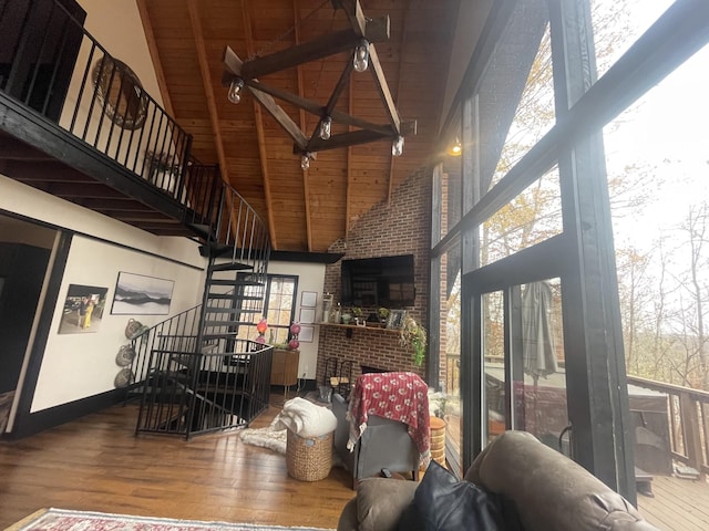2029 Holly Creek Rd, Celina, TN 38551 - living area featuring high vaulted ceiling, wooden ceiling with exposed beams, wood finished floors, stairs, and baseboards