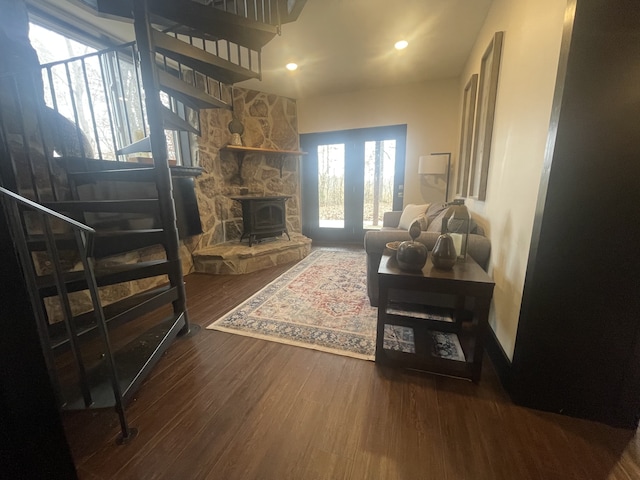 living room with hardwood / wood-style floors and a wood stove