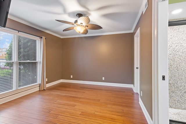 unfurnished room featuring ceiling fan, ornamental molding, and light hardwood / wood-style flooring