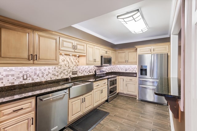 kitchen featuring hardwood / wood-style floors, tasteful backsplash, sink, dark stone countertops, and stainless steel appliances