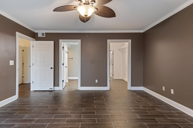 unfurnished bedroom with ceiling fan, ornamental molding, and a spacious closet