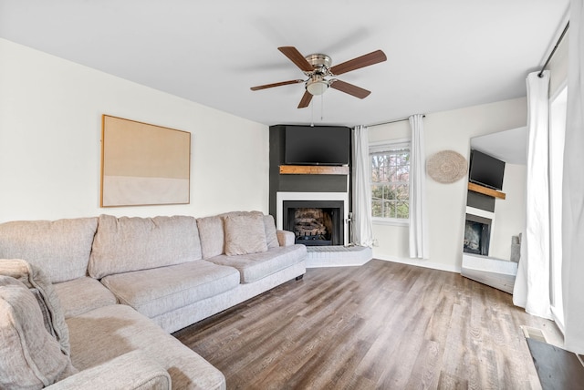 unfurnished living room featuring hardwood / wood-style floors and ceiling fan