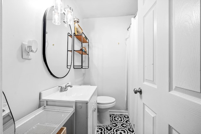 bathroom with tile patterned floors, vanity, and toilet