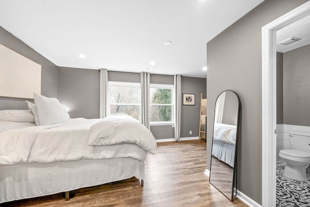 bedroom with wood-type flooring and ensuite bathroom