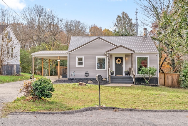 view of front facade with a front lawn and a carport