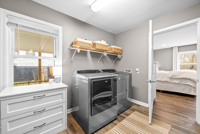 laundry area featuring dark hardwood / wood-style floors and washing machine and dryer